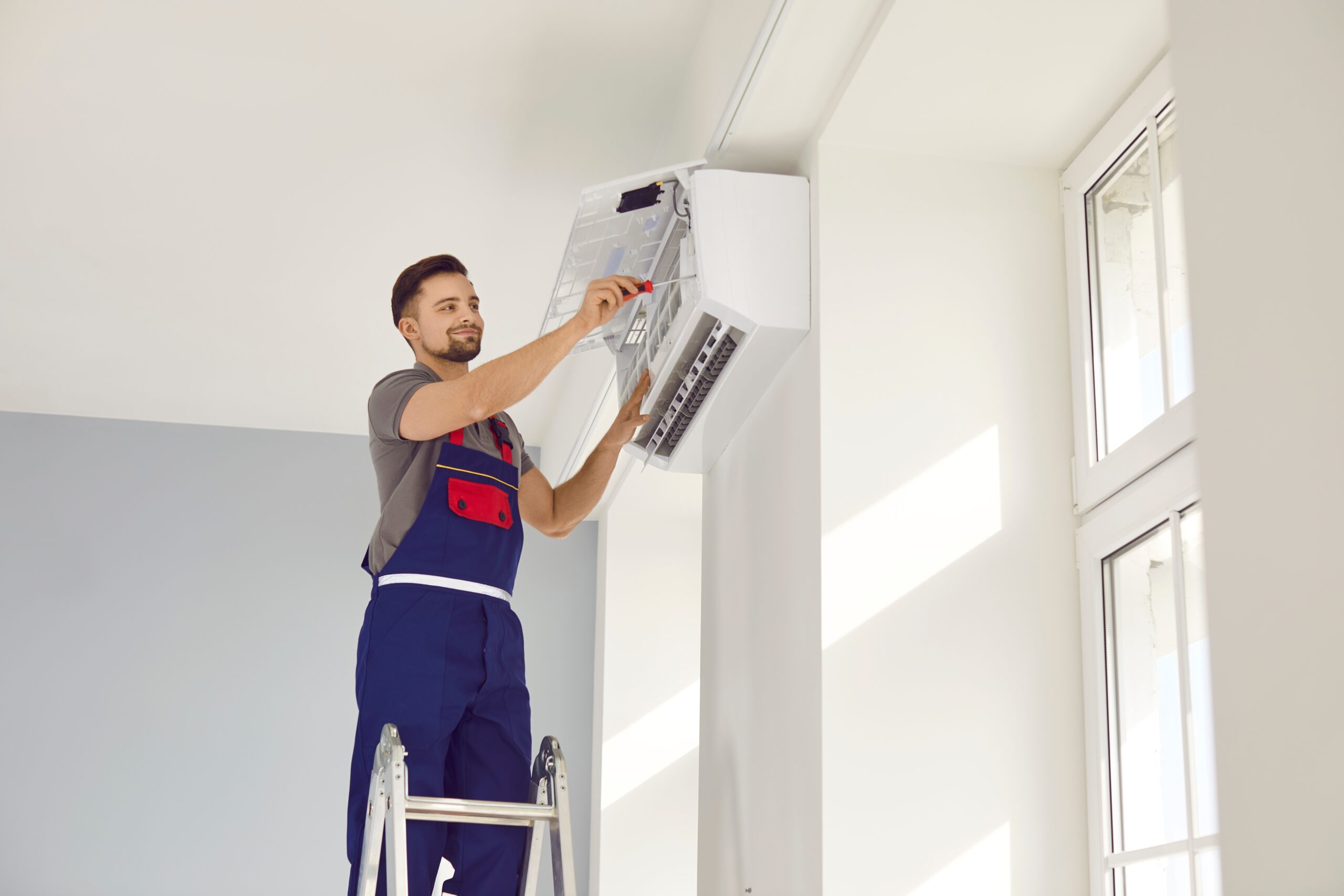 homeowner maintaining AC system and keeping your AC running strong in Rochester